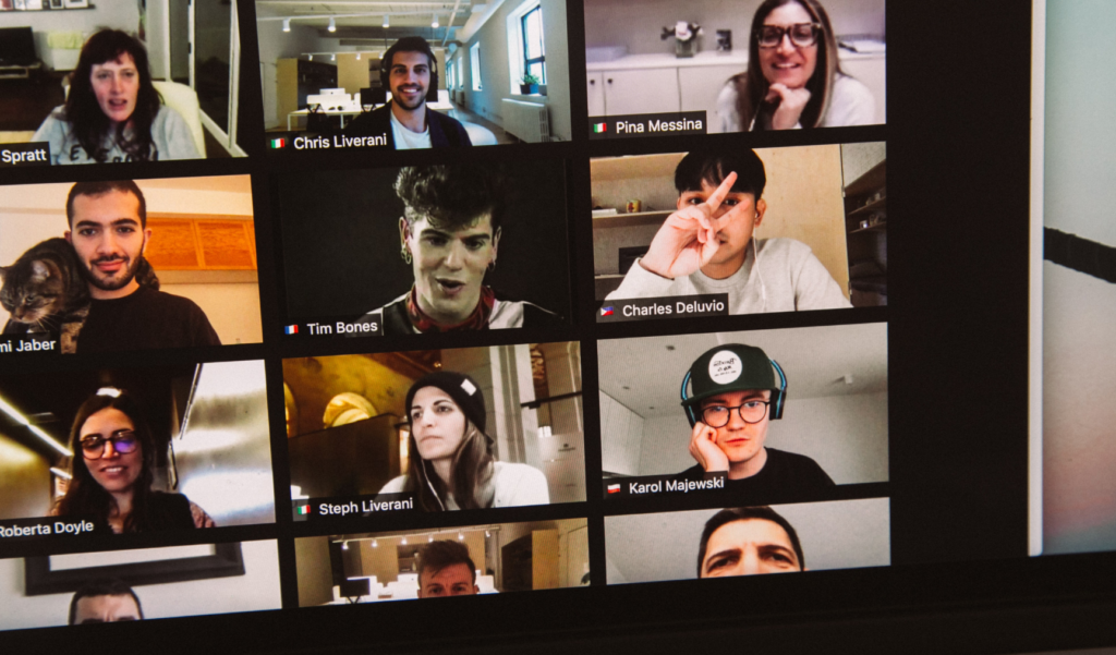 Grid view of a virtual video call with multiple participants, each in different locations, engaged in conversation and expressions.