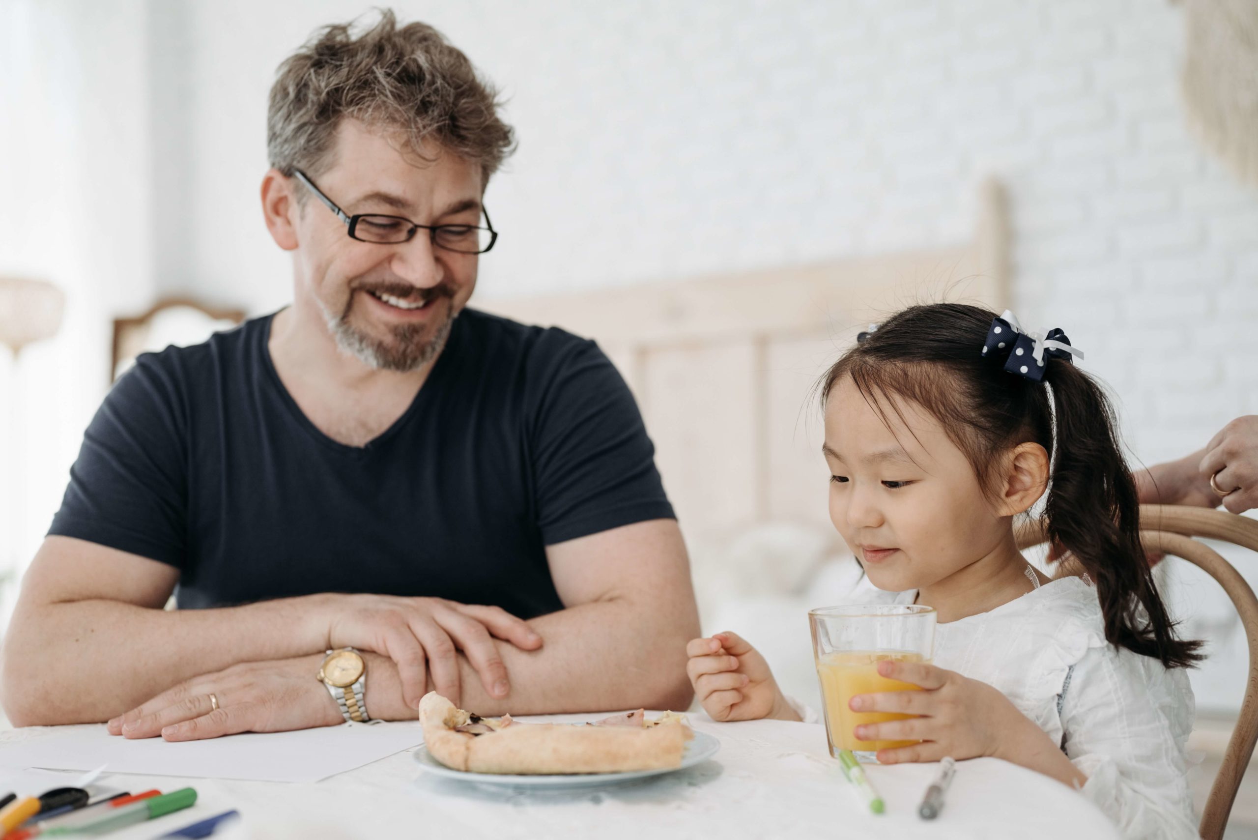 adoptive dad having breakfast with his adopted daughter