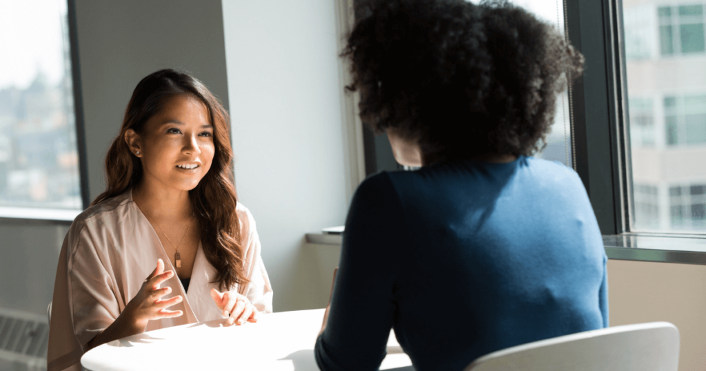 Two women talking at interview over a table