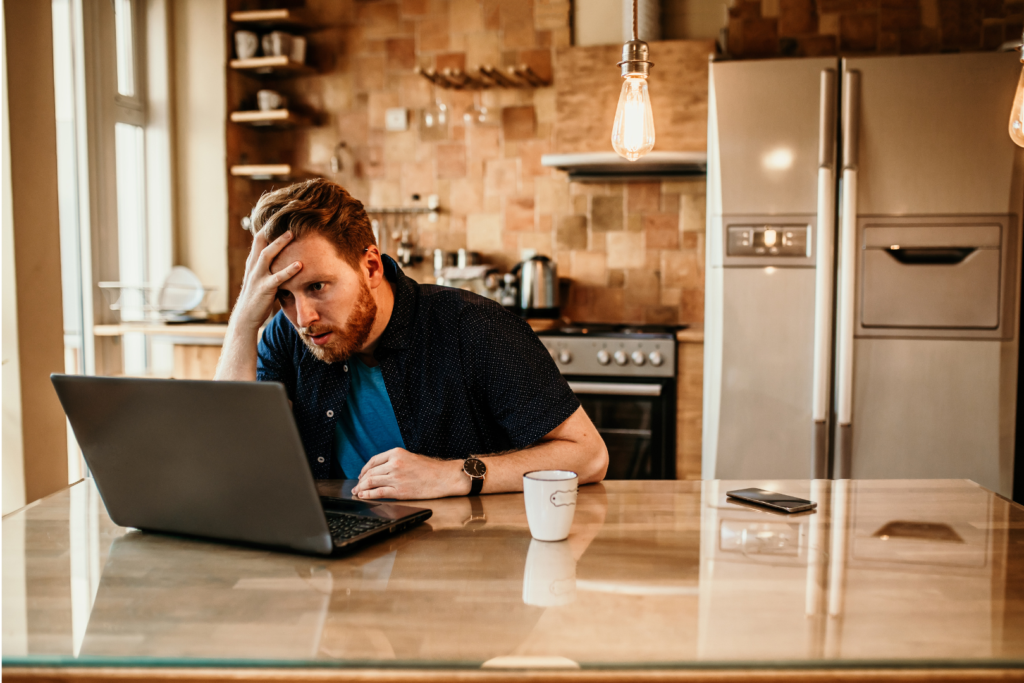 Man man with head in hand at desk