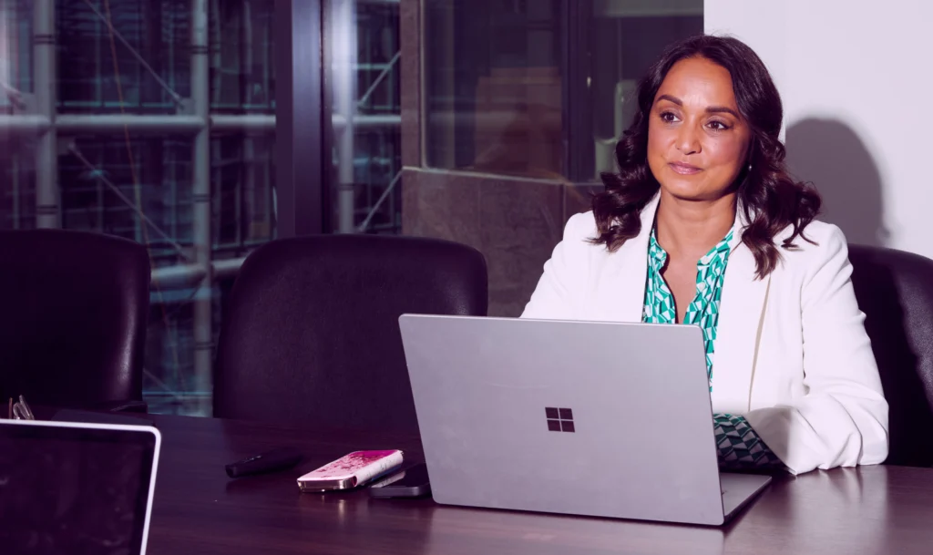 A corporate woman working in front of her laptop.