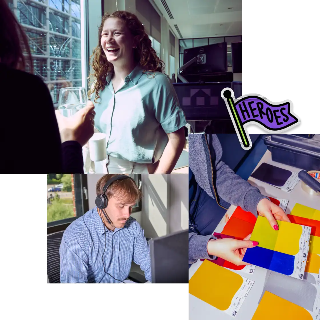 A woman laughs by a window holding a drink, a man with headphones focuses on a computer, and hands sort colorful paper. A "heroes" flag adds an uplifting tone.