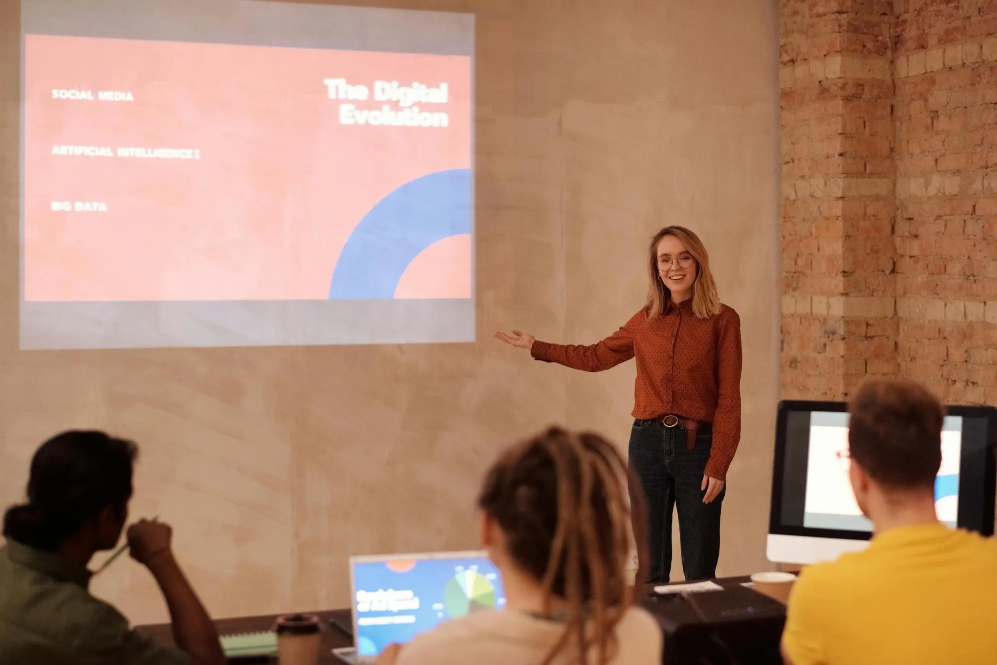 A woman pointing at her presentation in front of her colleagues