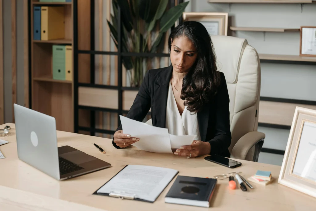 Woman reviewing papers on her desk