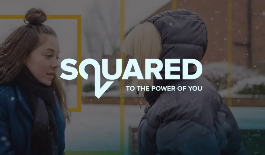 Two people in winter attire converse outdoors against a snowy backdrop. Overlaid text reads "Squared, To the Power of You." The mood is calm and reflective.