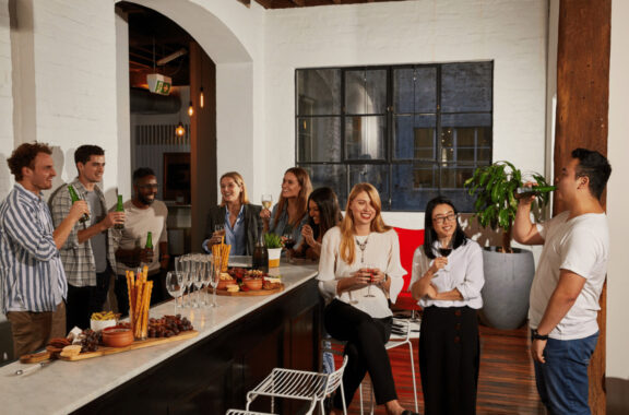 employees in the office socialising at the bar - workplace culture