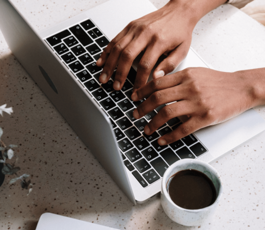 image of a person typing on a laptop