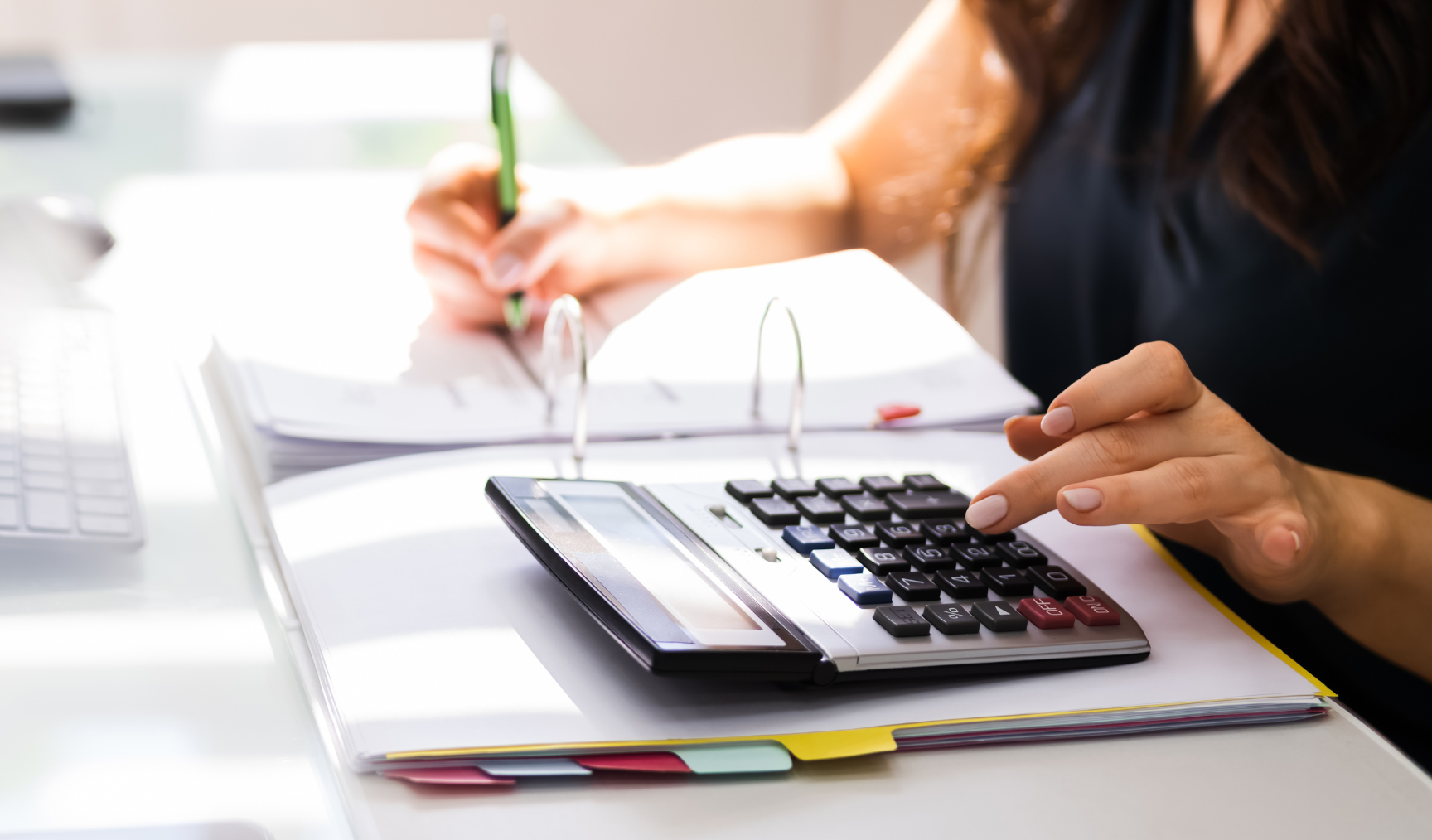 woman using the calculator at work