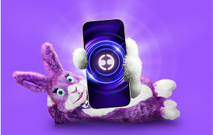 Purple and white plush rabbit lying down, holding a smartphone with a glowing circular logo on a purple background.