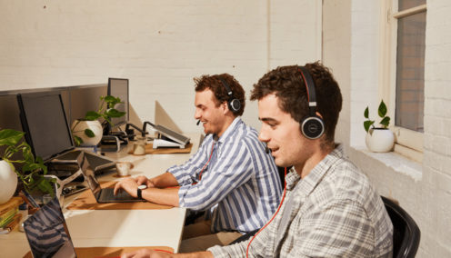 image of two males sitting at their desk working - value from employment hero