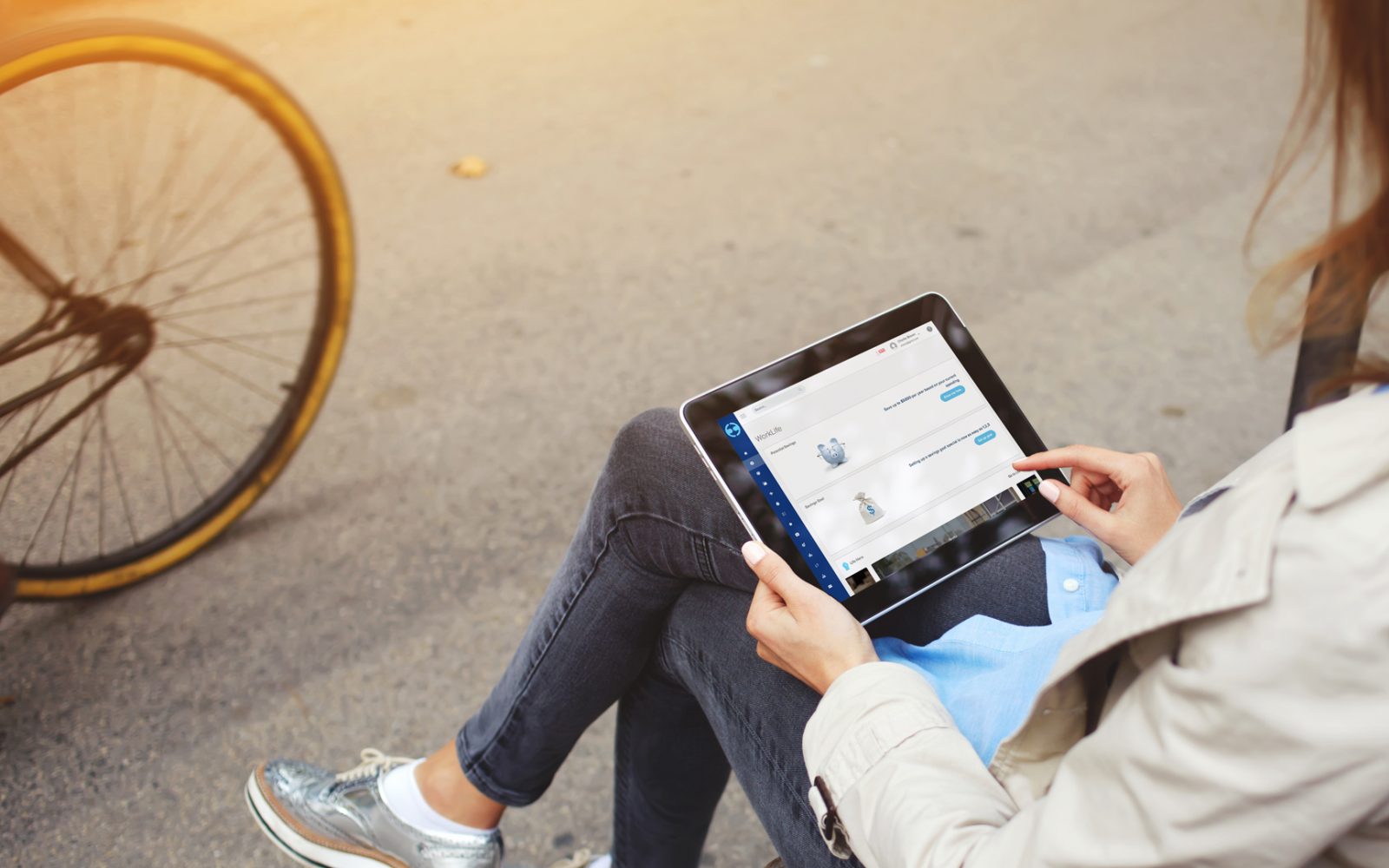 Girl sitting on iPad learning on Learning Plus