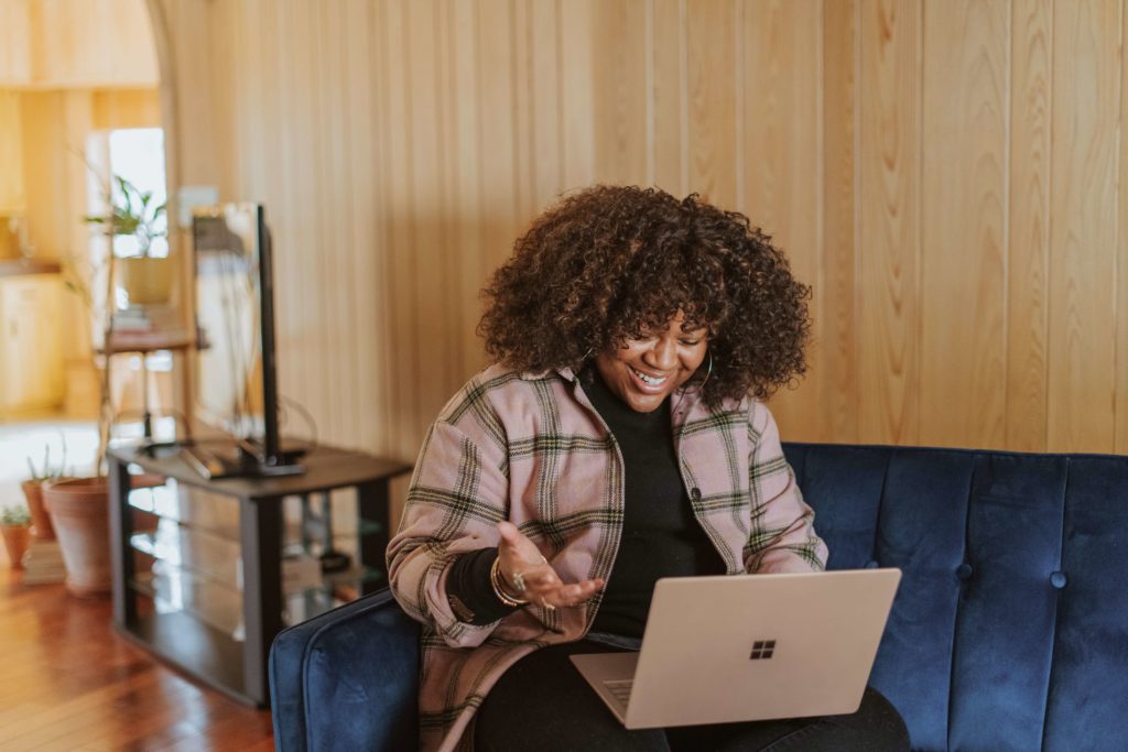 woman smiling at her laptop