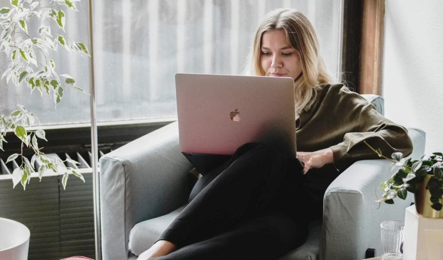 end of year hr bundle - woman sitting on her laptop at work