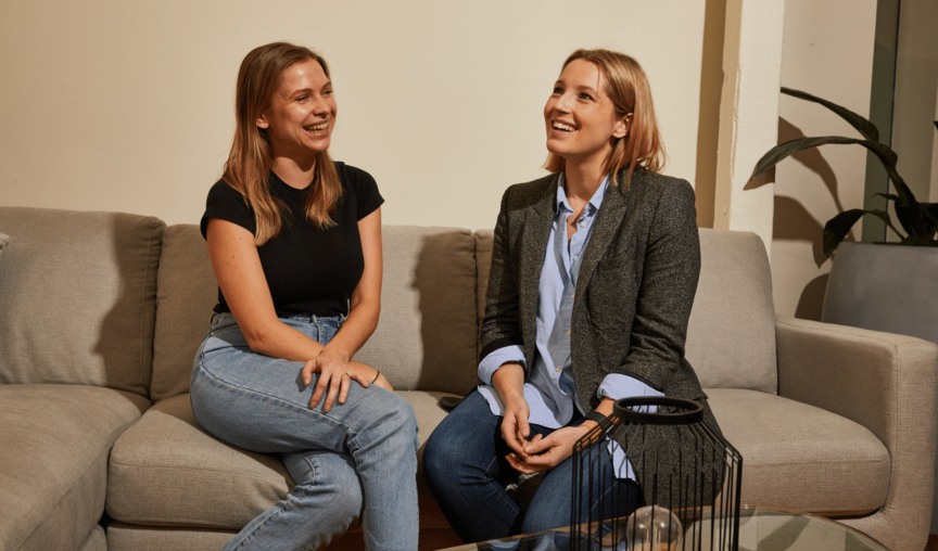 Two women completing an onboarding process smiling