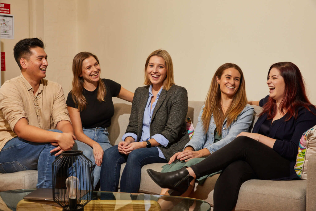 Five members of the Employment Hero team laughing