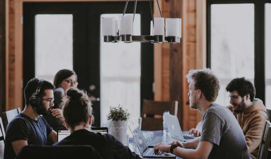 image of workforce sitting in a meeting - headcount planning