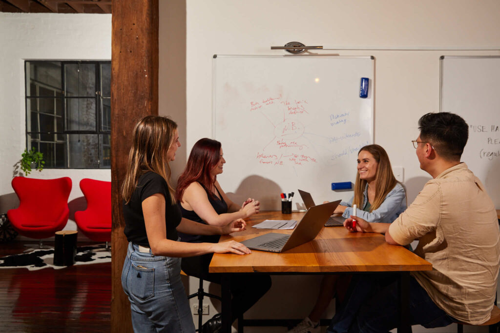 workmates talking around a table