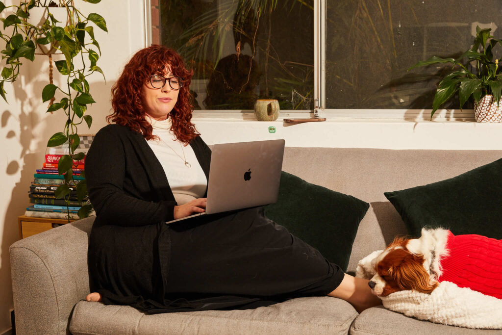 Woman on her sofa working at home