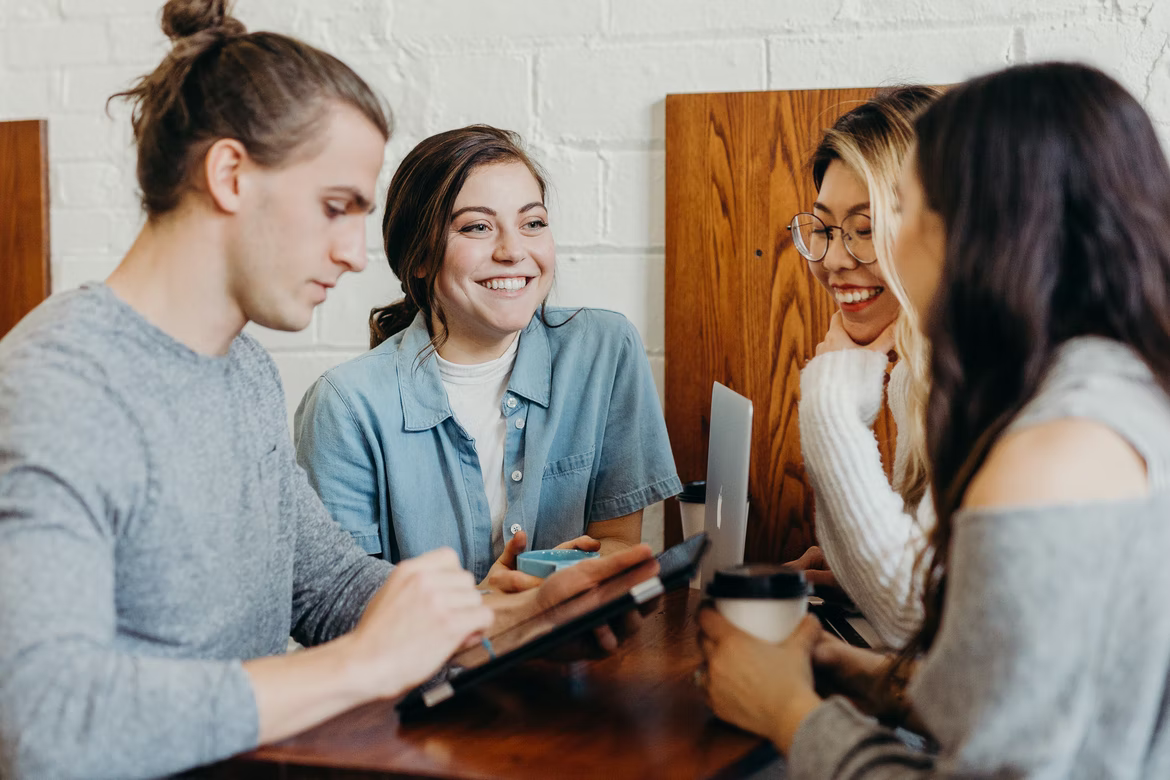 group of people chatting together at a table