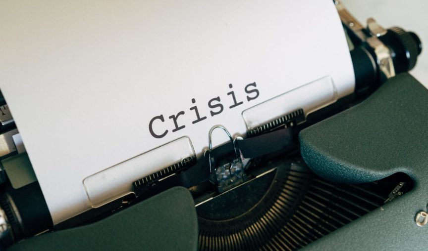 the word 'crisis' typed out on a typewriter