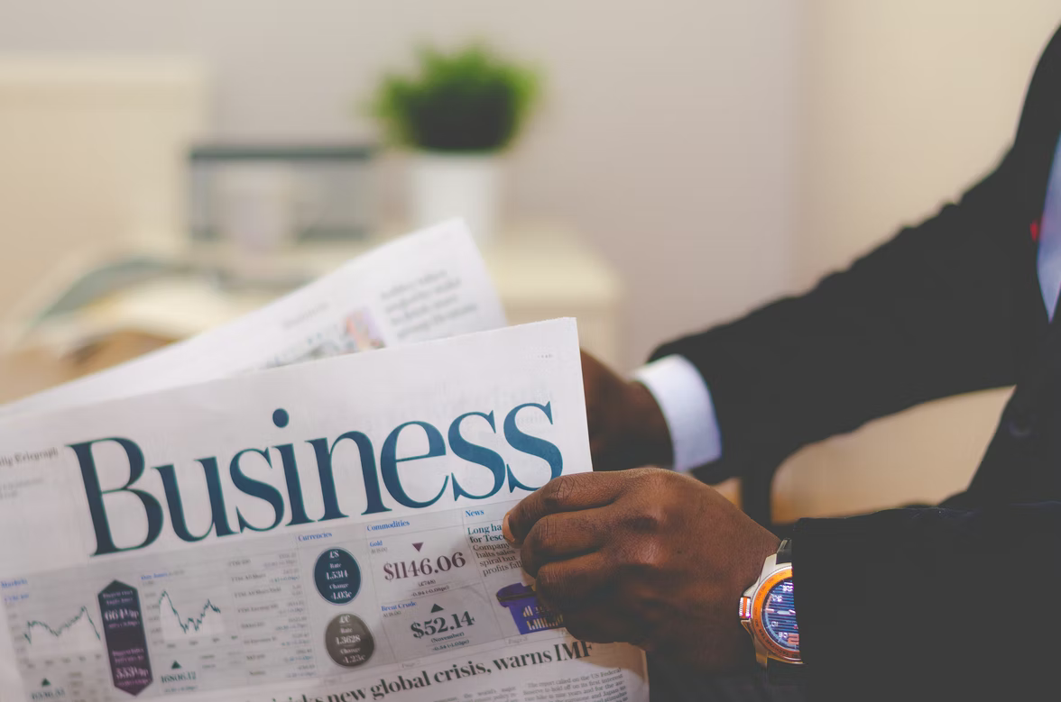 Man holding a business newspaper