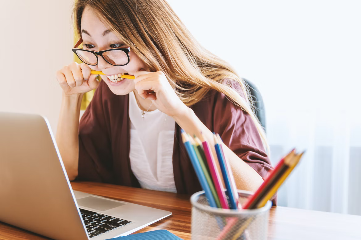 woman at work biting a pencil