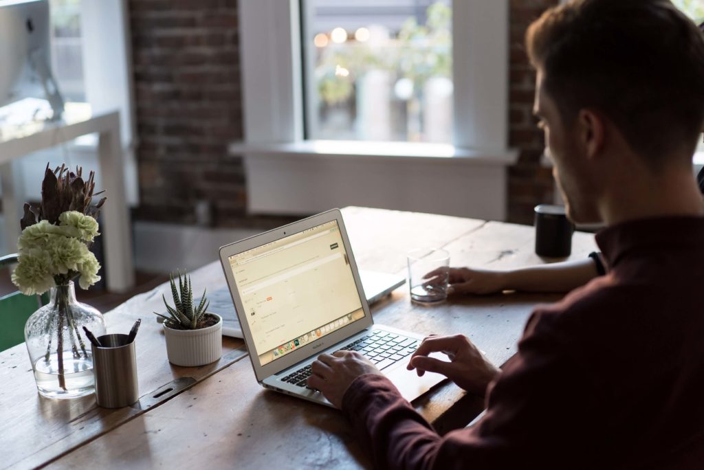 man viewing his digital employment contract on his laptop