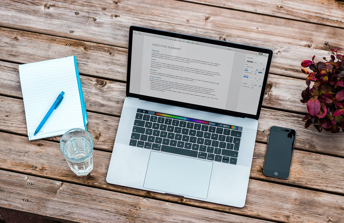 open laptop, notebook and phone on a table