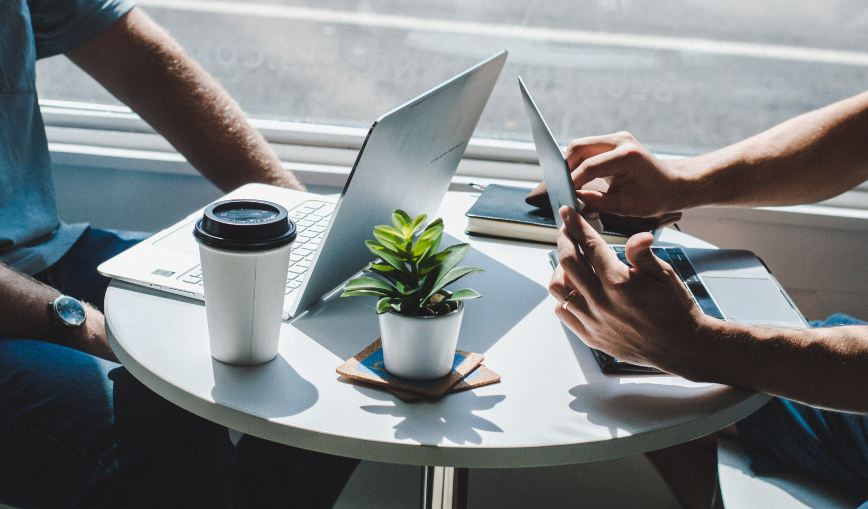 two people discussing business with coffee 