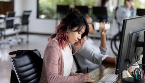 Image of a woman sitting at her desk working
