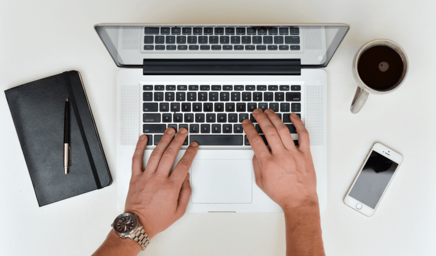 Person using laptop in the office.