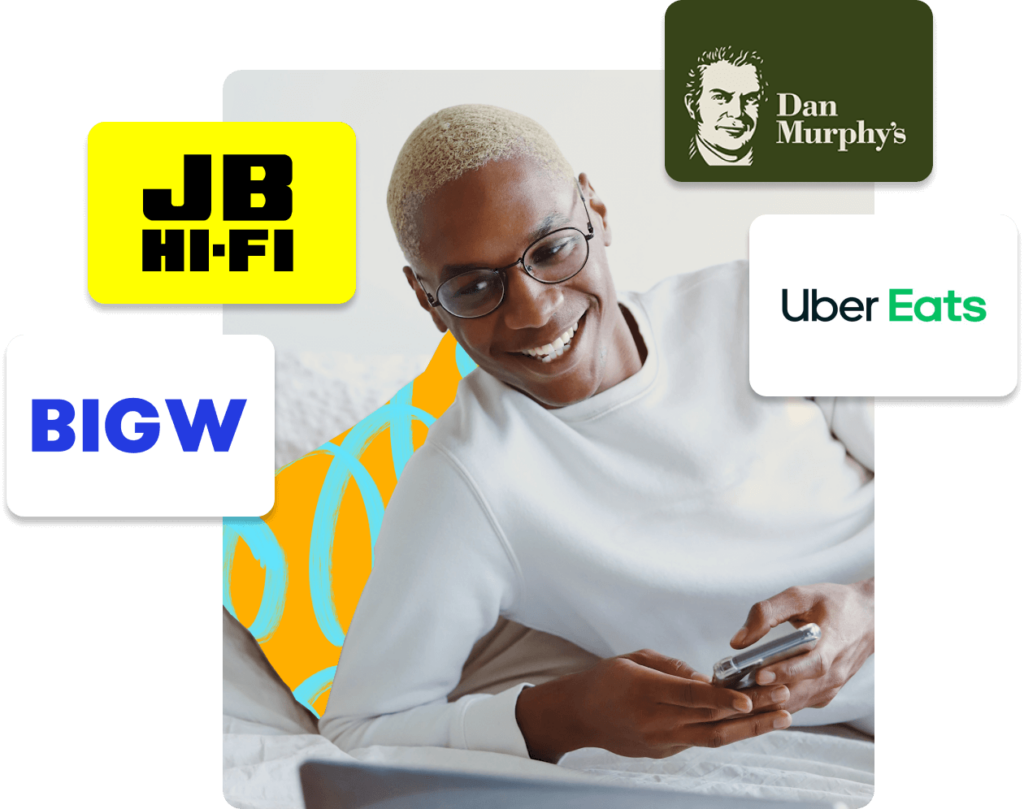 Smiling person holding a phone, surrounded by logos of popular brands including JB Hi-Fi, Big W, Dan Murphy's, and Uber Eats, representing gift card options