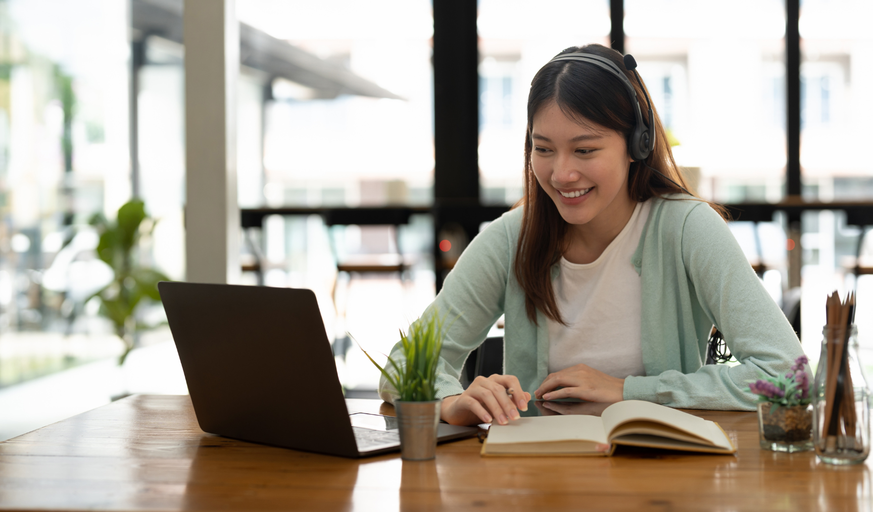 woman attending an online workshop on her laptop and having a good time