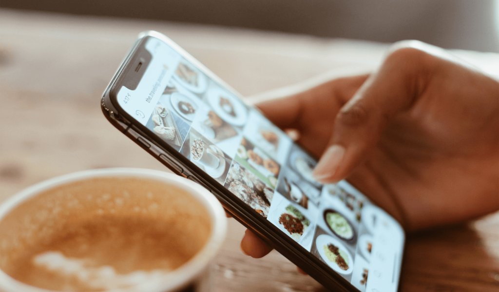 a person scrolling through their Instagram feed on their phone