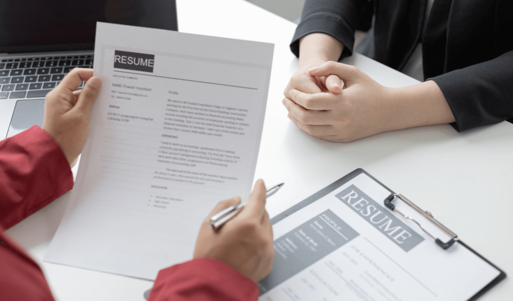 two people having an interview where one person is looking at the other person's resume