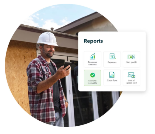 A photo of a man in a construction setting wearing a hard hat and holding a smartphone
