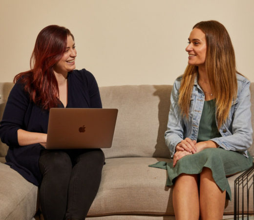 A photo of two women talking to each other