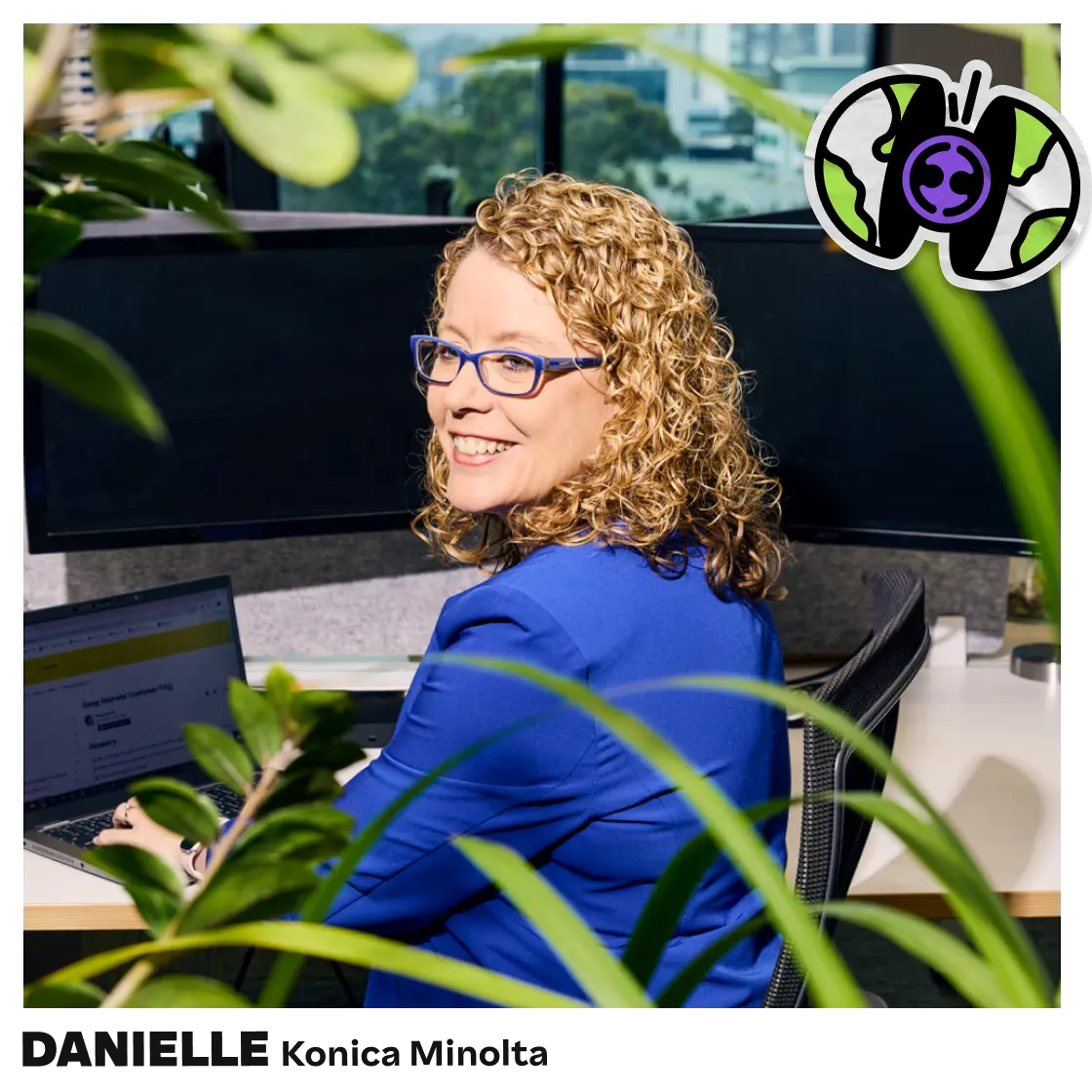 Smiling woman with curly hair at her desk, surrounded by plants, with a stylized globe and butterfly icon overlay.