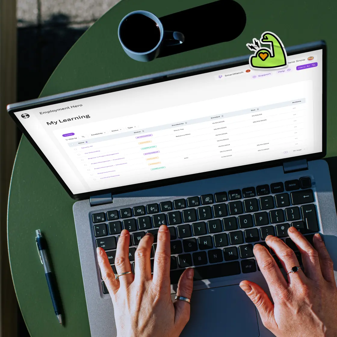 Hands on a laptop keyboard display an e-learning platform interface with progress statuses.