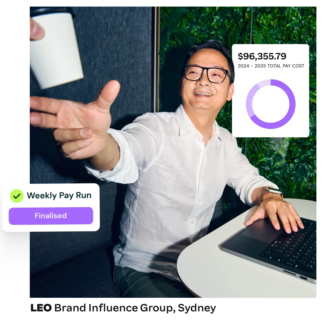 A man smiles and reaches for a takeaway coffee cup at a desk, while payroll summary data and pay run status appear.