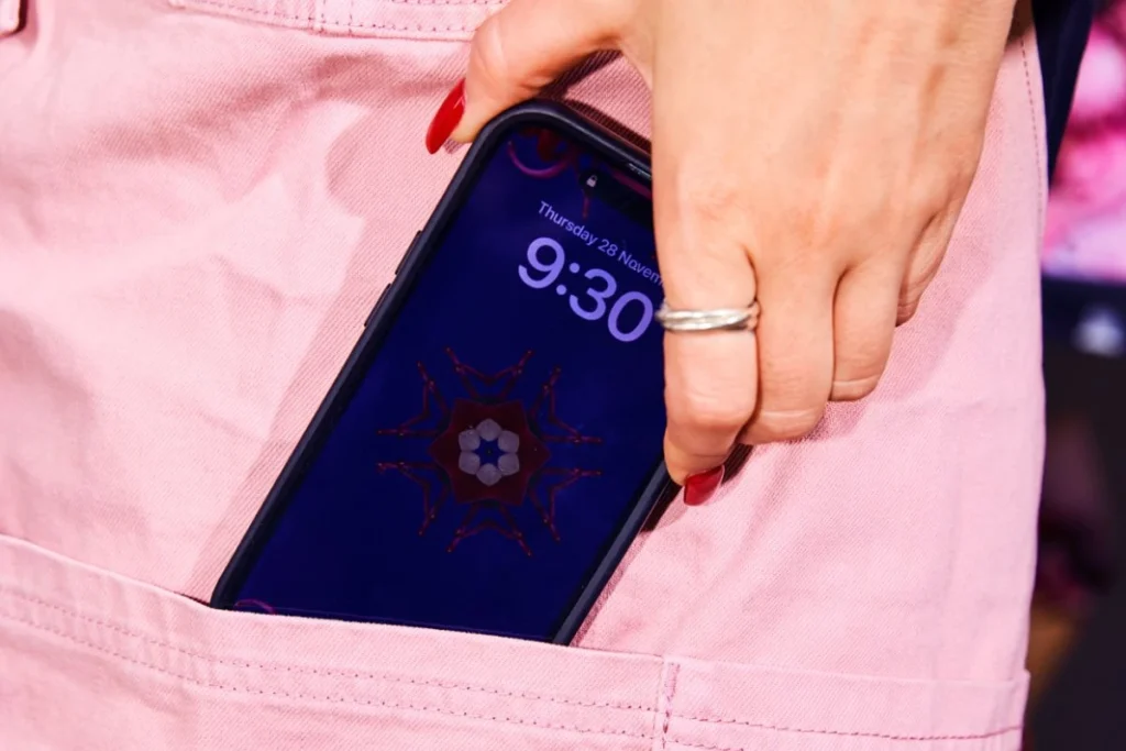A woman slipping her phone in her pocket