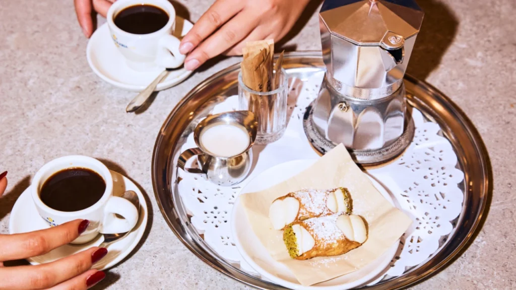 Overhead image of a table with coffee and a tray of snacks