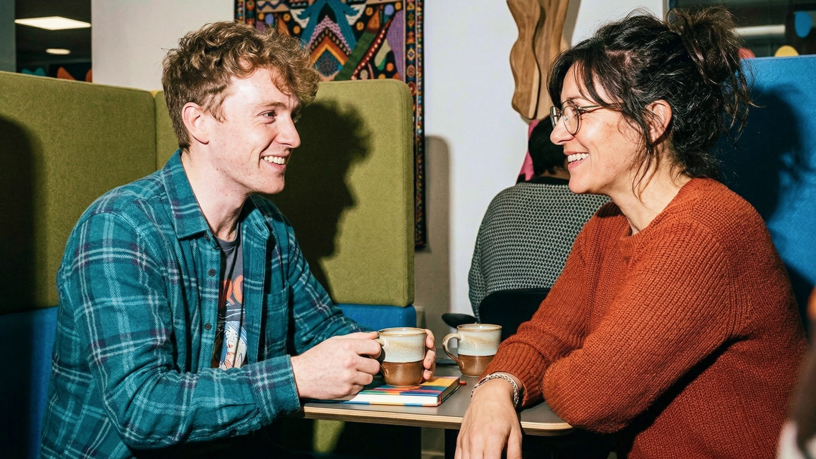 A man and a woman conversing over coffee