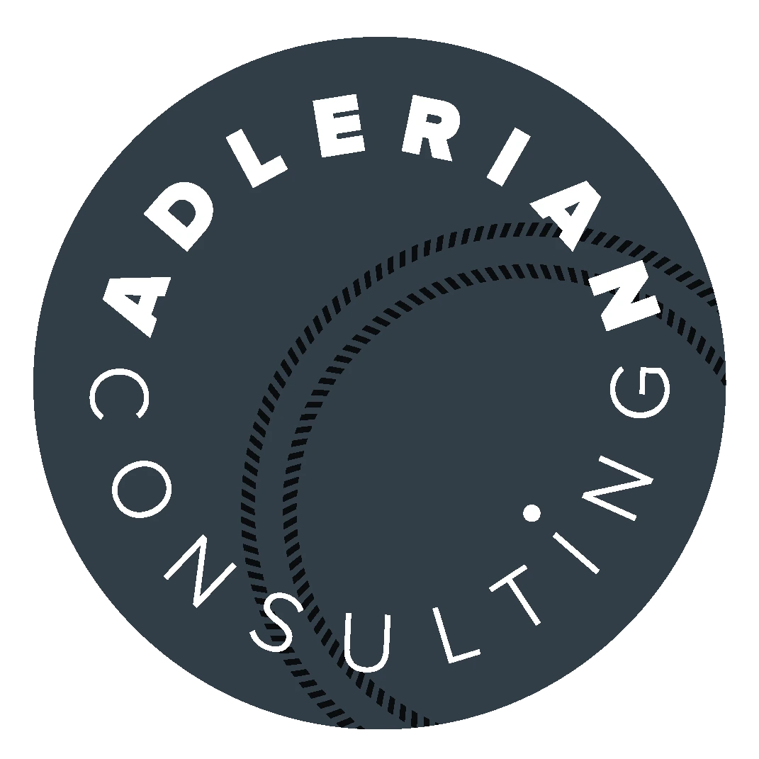 Dark gray circular logo for "Adlerian Consulting" with white text and dotted curved lines, creating a sense of professionalism and modernity.