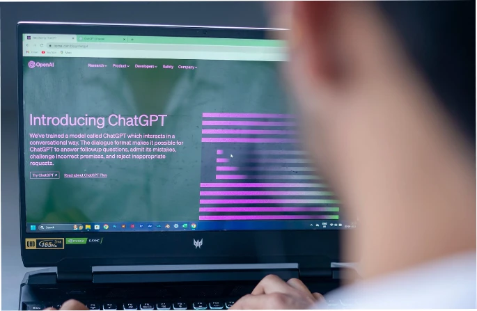 Someone reading OpenAI's ChatGPT announcement on a laptop