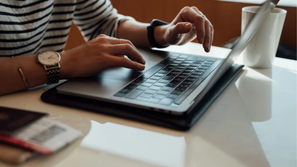 Close up image of hands using a laptop