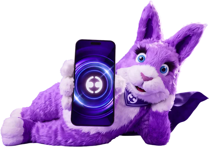 Big Ears, the Employment Hero bunny, lying down and holding up a phone with the Employment Hero logo